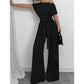 Elegáns aszimmetrikus nyakkivágású pöttyös jumpsuit