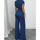 Elegáns aszimmetrikus nyakkivágású pöttyös jumpsuit