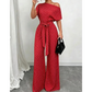 Elegáns aszimmetrikus nyakkivágású pöttyös jumpsuit